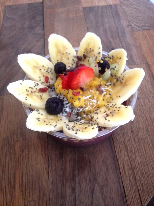 Flower Bowl (Blended acai base, topped with granola, fresh fruits, bee pollen, cacao nibs, coconut shaving, chia seeds and goji berries)